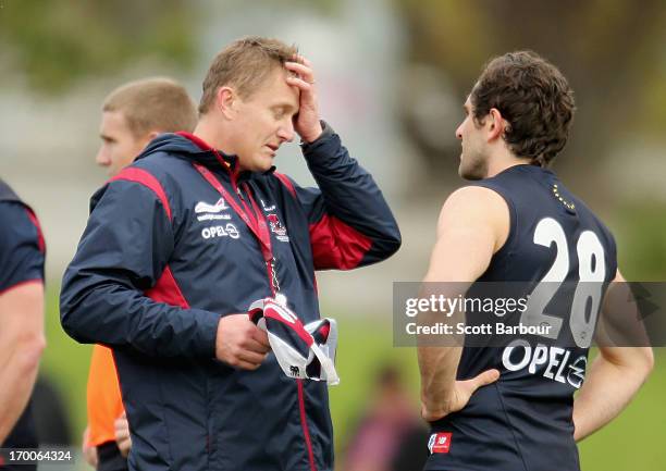 Demons coach Mark Neeld speaks to Joel Macdonald of the Demons during a Melbourne Demons AFL training session at Gosch's Paddock on June 7, 2013 in...