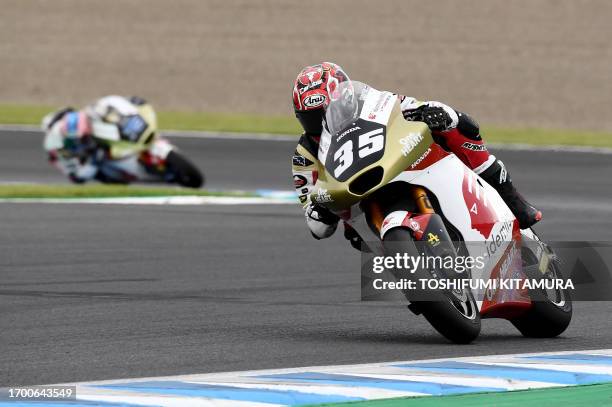 Honda Team Asia rider Somkiat Chantra of Thailand leads his teammate Ai Ogura of Japan during the Moto2 class race of MotoGP Japanese Grand Prix at...