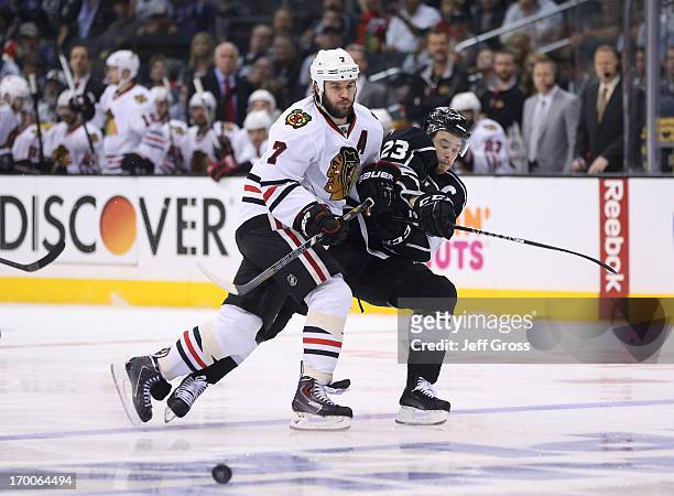 Brent Seabrook of the Chicago Blackhawks checks Dustin Brown of the Los Angeles Kings near the blueline in the second period of Game Four of the...
