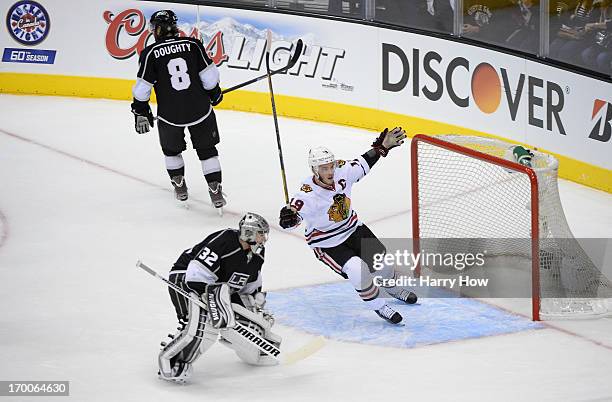 Jonathan Toews of the Chicago Blackhawks reacts after a goal by teammate Bryan Bickell of the Chicago Blackhawks as goaltender Jonathan Quick of the...