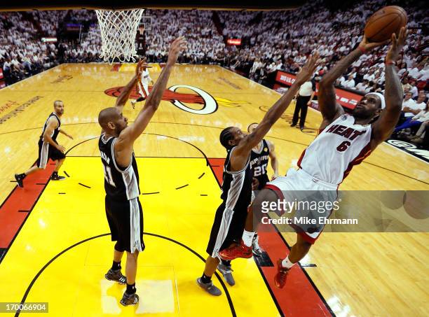 LeBron James of the Miami Heat shoots over Kawhi Leonard of the San Antonio Spurs in the third quarter during Game One of the 2013 NBA Finals at...