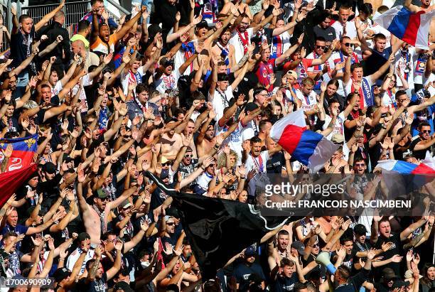 Lyon's supporters cheer up ahead of the French L1 football match between Stade de Reims and Olympique Lyonnais at Stade Auguste-Delaune in Reims,...