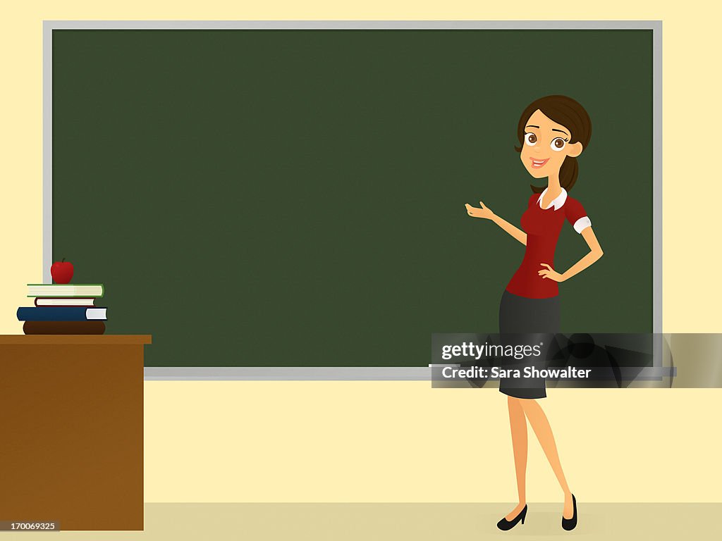 A teacher standing at the chalkboard