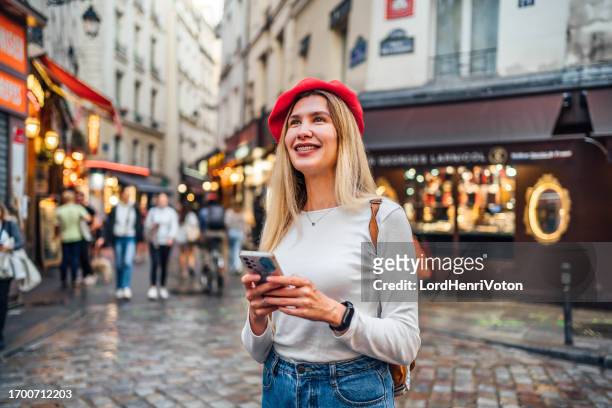 woman using phone in latin quarter in paris, france - latin quarter stock pictures, royalty-free photos & images