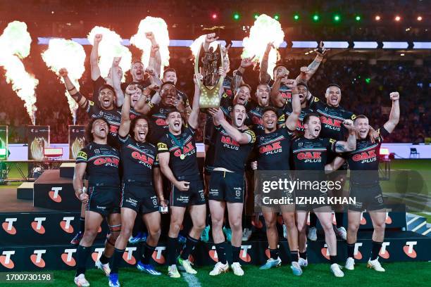 Panthers players celebrate with the trophy after winning the 2023 NRL Grand Final match between Penrith Panthers and Brisbane Broncos at Accor...