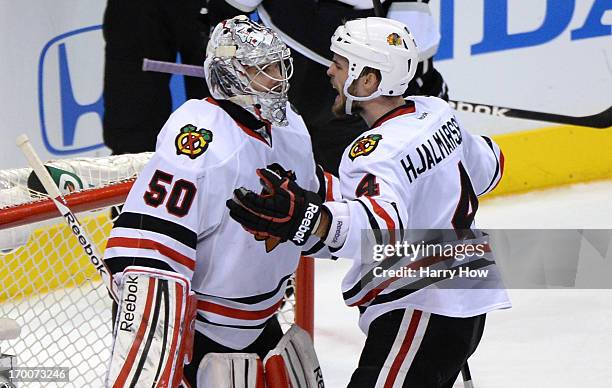 Niklas Hjalmarsson of the Chicago Blackhawks shouts after they defeated the Los Angeles Kings 3-2 as goaltender Corey Crawford looks on in Game Four...