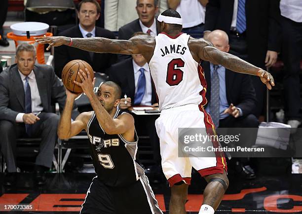 Tony Parker of the San Antonio Spurs makes a shot with 5.2 seconds left in the fourth quarter against LeBron James of the Miami Heat during Game One...