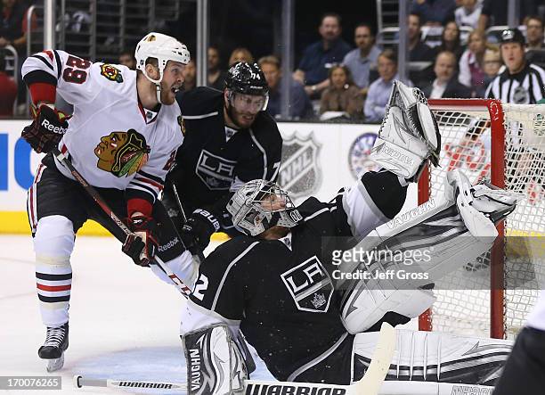 Goaltender Jonathan Quick of the Los Angeles Kings makes a glove save on a shot by Patrick Kane of the Chicago Blackhawks from the right wing as...