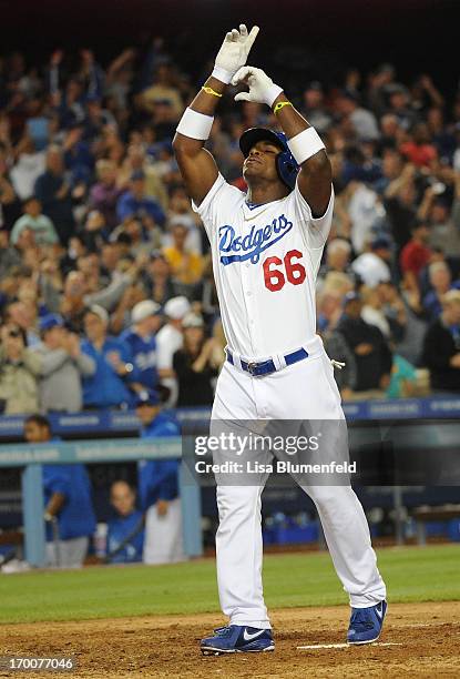 Yasiel Puig of the Los Angeles Dodgers celebrates at homeplate after hitting a grandslam homerun in the eighth inning against the Atlanta Braves at...