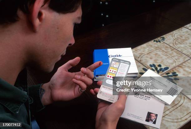 Young man is photographed October 10, 1996 in New York City following the instructions of Confide, the first home collection HIV testing kit...