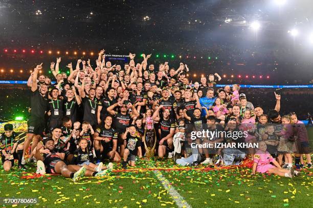 Panthers players and team staff celebrate with the trophy after winning the 2023 NRL Grand Final match between Penrith Panthers and Brisbane Broncos...