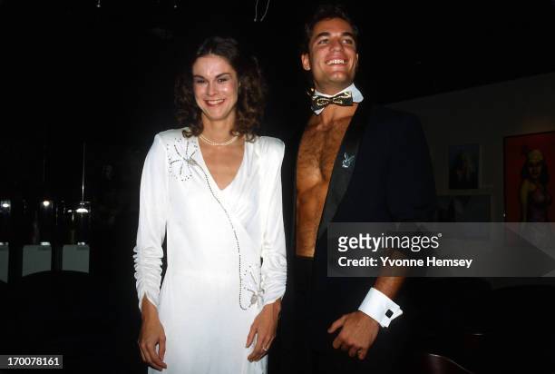Christie Hefner and a male bunny are photographed October 29, 1985 at the re-opening of the Playboy club in New York City.