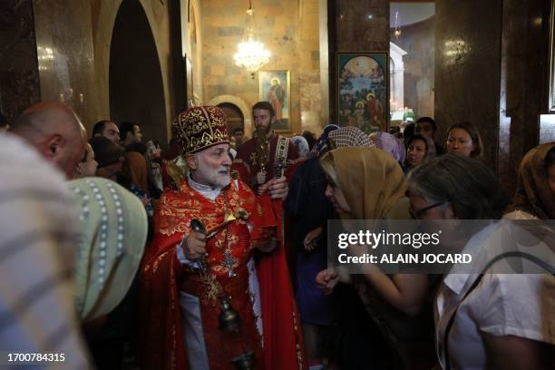 Father Shahe Hayrapetyan leads a service for the Nagorny Karabakh refugees at the Saint-Sargis vicarial church as part of the nationwide prayer for...