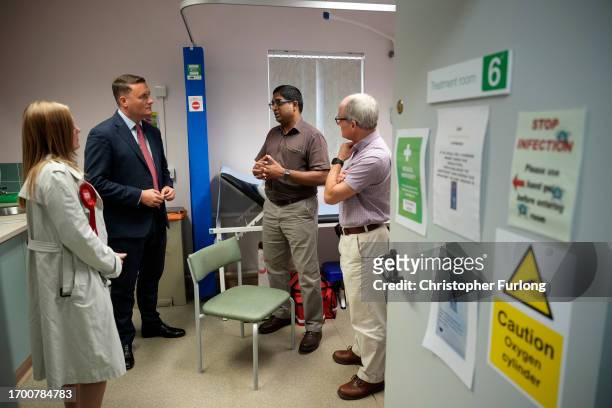 Labour's shadow health secretary Wes Streeting and the party's candidate for the Tamworth by-election Sarah Edwards, talk to doctors Stephan Benkert,...