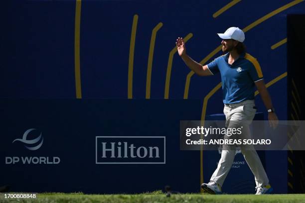 Europe's English golfer, Tommy Fleetwood arrives on the 1st tee for his singles match against US golfer, Rickie Fowler on the final day of play in...