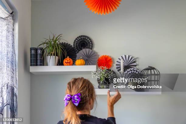 woman decorating the room for halloween - hair bow stock pictures, royalty-free photos & images