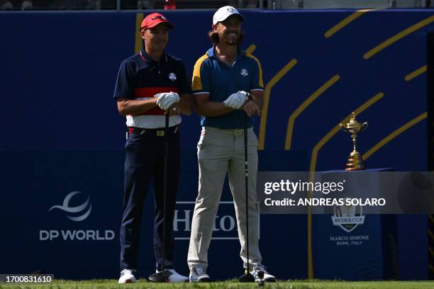 Golfer, Rickie Fowler and Europe's English golfer, Tommy Fleetwood pose on the 1st tee ahead of their singles match on the final day of play in the...