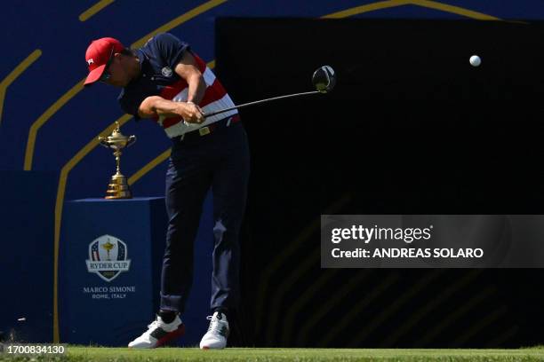 Golfer, Rickie Fowler plays from the 1st tee during his singles match against Europe's English golfer, Tommy Fleetwood on the final day of play in...