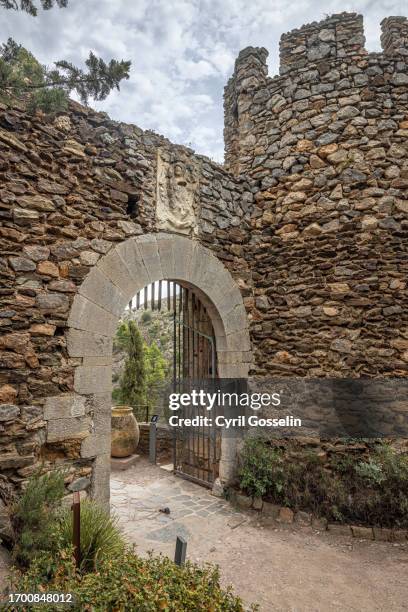 gate in the ramparts of medieval village castelnou, occitania, france. - old castle entrance stock pictures, royalty-free photos & images