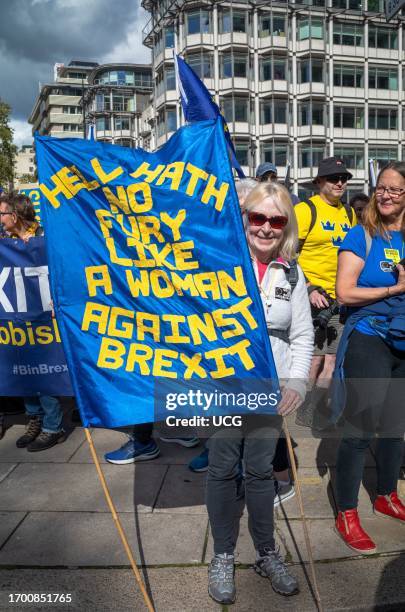 An English woman holds a Brexit protest banner at the EU National Rejoin March in central London. Thousands of people marched across the city in...