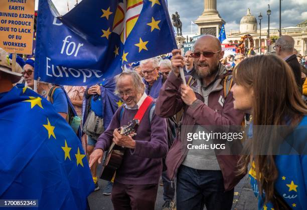 London, UK, 23 Sep 2023, An elderly man plays guitar and sings as he marches with anti-Brexit protesters at the EU National Rejoin March in Trafalgar...