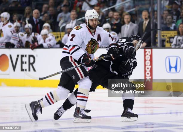 Brent Seabrook of the Chicago Blackhawks checks Dustin Brown of the Los Angeles Kings near the blueline in the second period of Game Four of the...