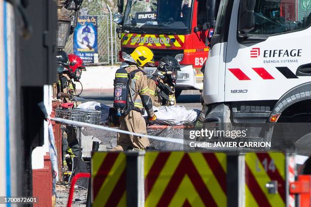 Firefighters carry out a stretcher as at least eleven people were killed in a fire at the Teatre nightclub in Murcia, on October 1, 2023. At least 13...