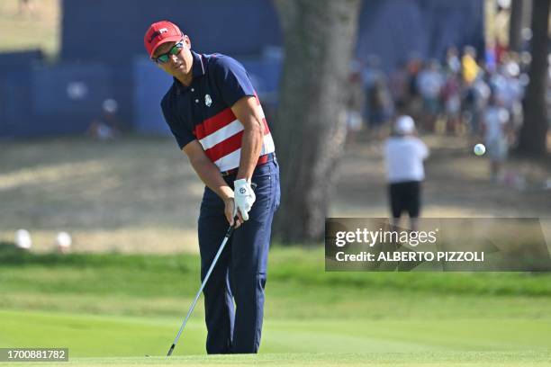 Golfer, Rickie Fowler chips onto the 2nd green during his singles match against Europe's English golfer, Tommy Fleetwood on the final day of play in...