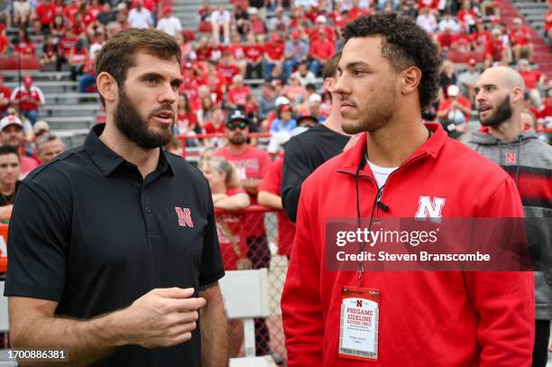 Former quarterbacks Taylor Martinez and Adrian Martinez of the Nebraska Cornhuskers meet on the field before the game against the Louisiana Tech...