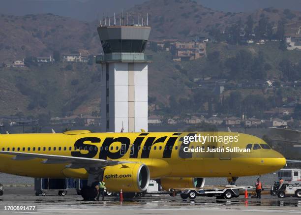 The control tower at Hollywood Burbank Airport stands over a Spirit Airlines plane as it taxis on September 25, 2023 in Burbank, California....