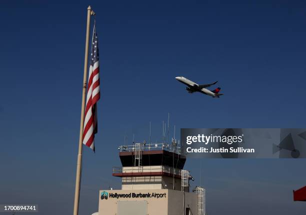 Delta Airlines plane takes off past the control tower at Burbank Hollywood Airport on September 25, 2023 in Burbank, California. Transportation...