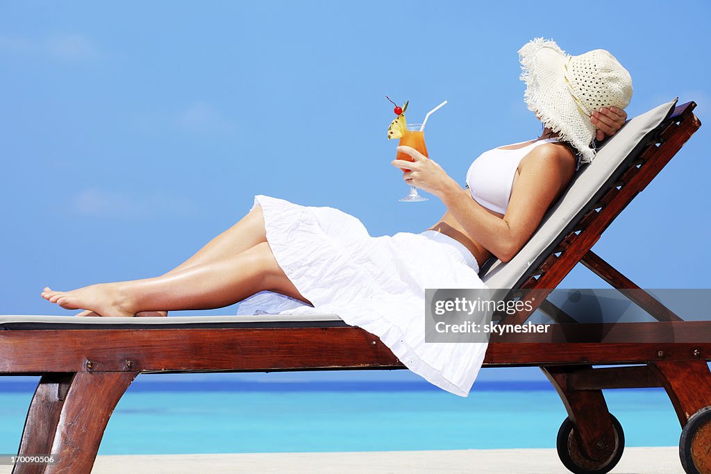 Young woman enjoying in cocktail.