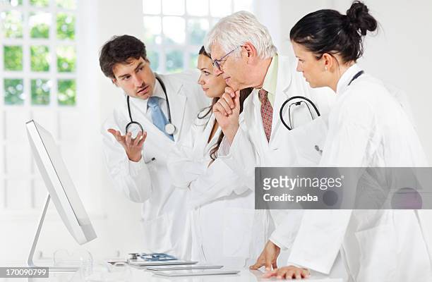 group of doctors discussing and using a digital tablet ,computor - computor bildbanksfoton och bilder