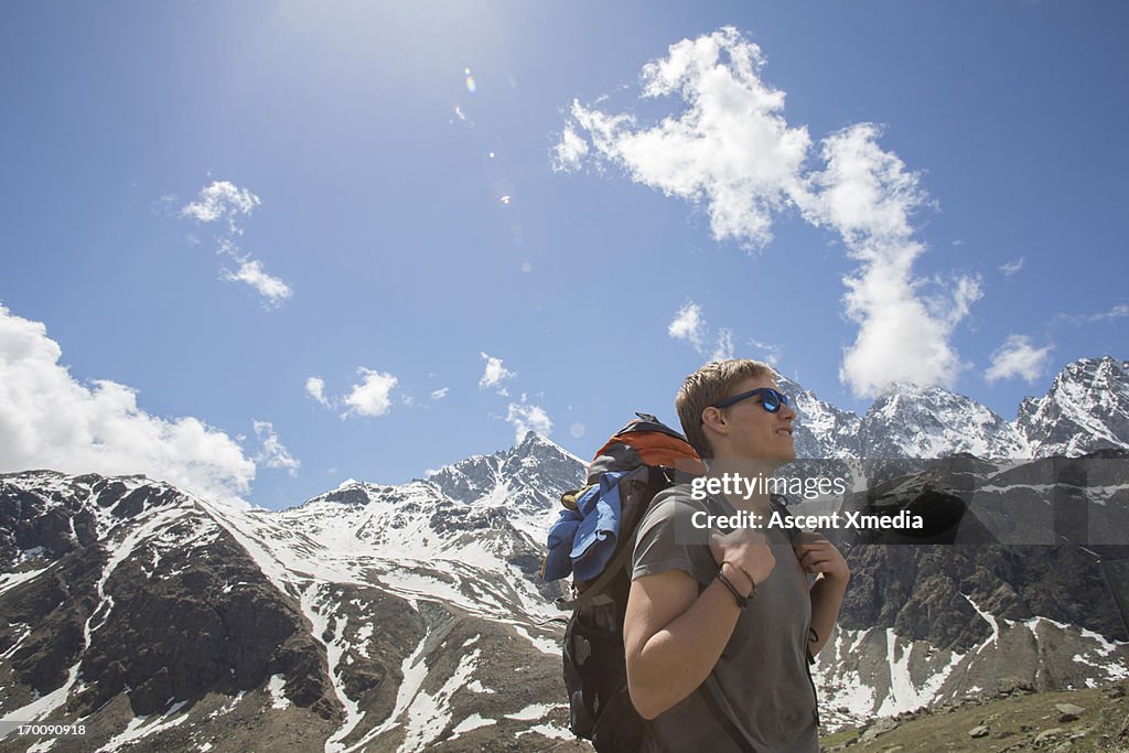 Young man looks to route ahead, above mtns