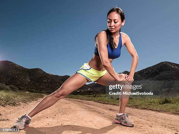 crossing country runner - joint effort stock pictures, royalty-free photos & images