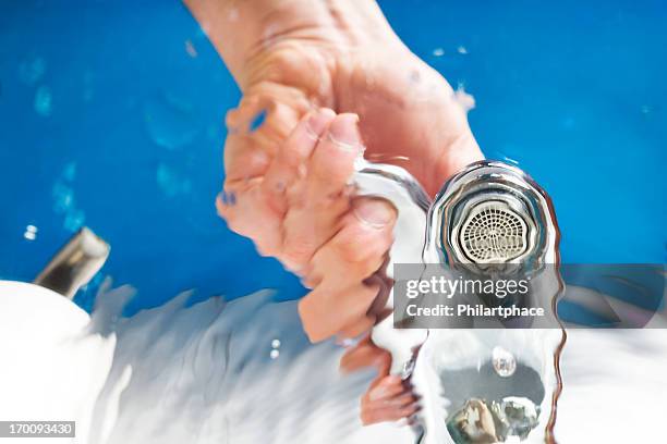 hand opening water tap - underwater room stock pictures, royalty-free photos & images