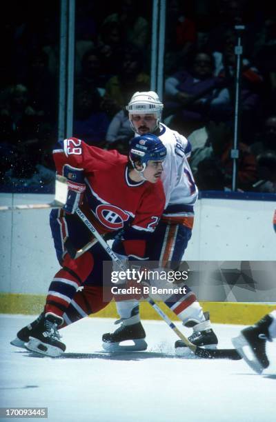 John Chabot of the Montreal Canadiens is defended by Bryan Trottier of the New York Islanders during the 1984 Conference Finals in May, 1984 at the...