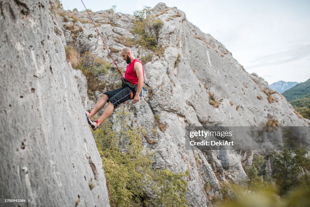 Step Terrain A Focused Male Climber Overcomes Extremely Steep Terrain By Climbing A ...
