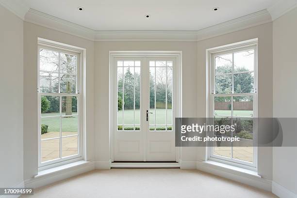 white bay windows and french doors - window stock pictures, royalty-free photos & images