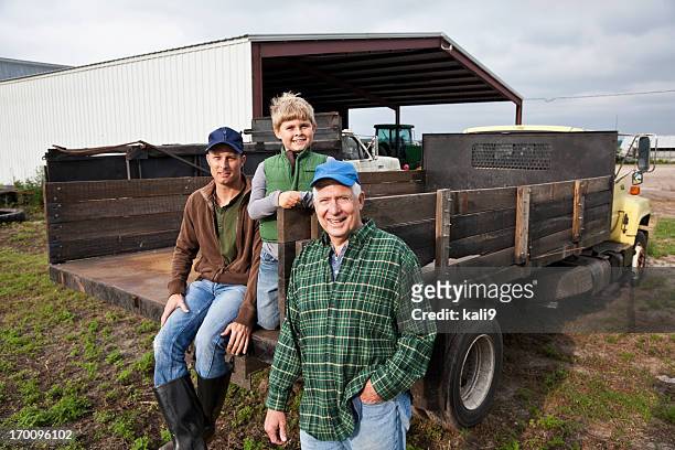 three generations of men on the family farm - farm family stockfoto's en -beelden