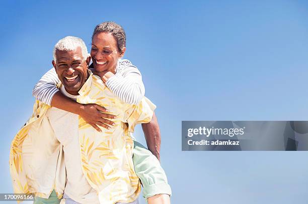 african american senioren huckepack nehmen - candid mature couple outdoors stock-fotos und bilder