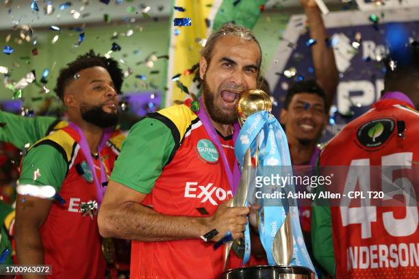 Imran Tahir, captain of Guyana Amazon Warriors celebrates with the Republic Bank Caribbean Premier League Trophy after winning the Republic Bank...