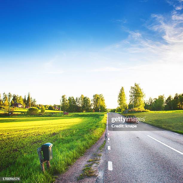 rural scene in sweden - driving sun stockfoto's en -beelden