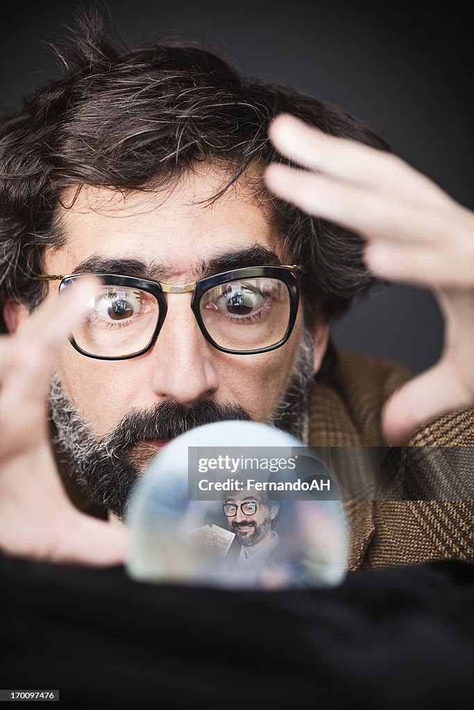 Man seeing his future in a crystal ball