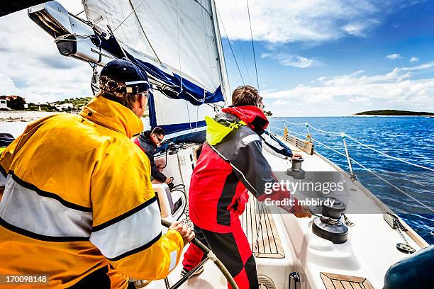 sailing crew beating to windward on sailboat - yacht crew stock pictures, royalty-free photos & images