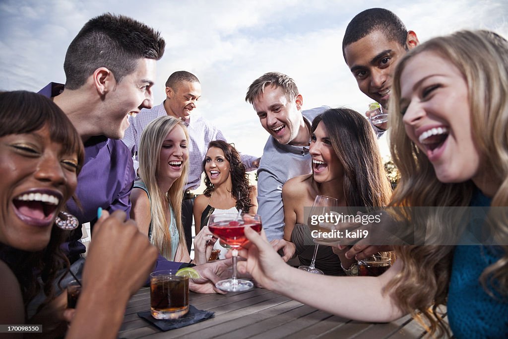 Group of young adults drinking outdoors