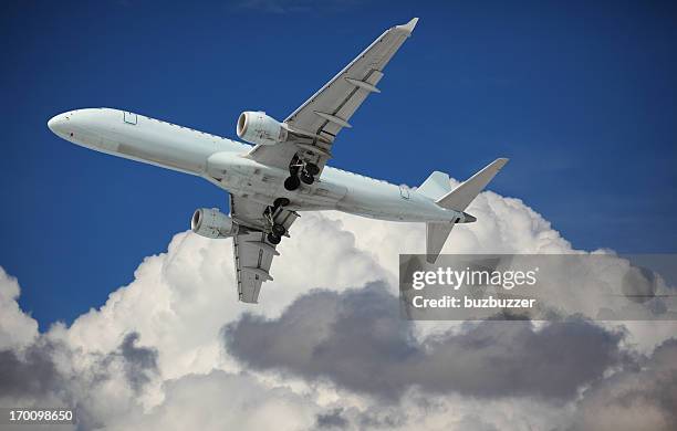 airplane in the sky above the clouds - plane fuselage stock pictures, royalty-free photos & images