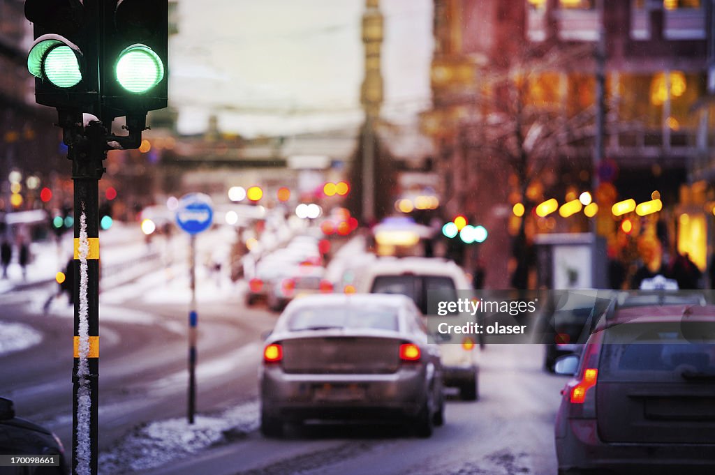 Bad weather, snow and rain in the evening traffic