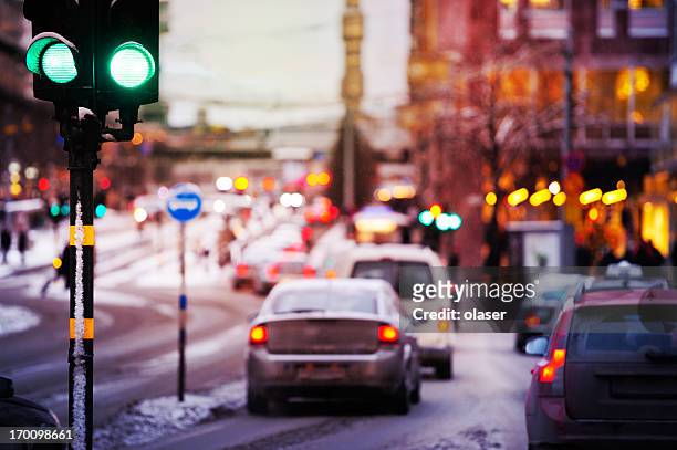 bad weather, snow and rain in the evening traffic - stockholm stock pictures, royalty-free photos & images
