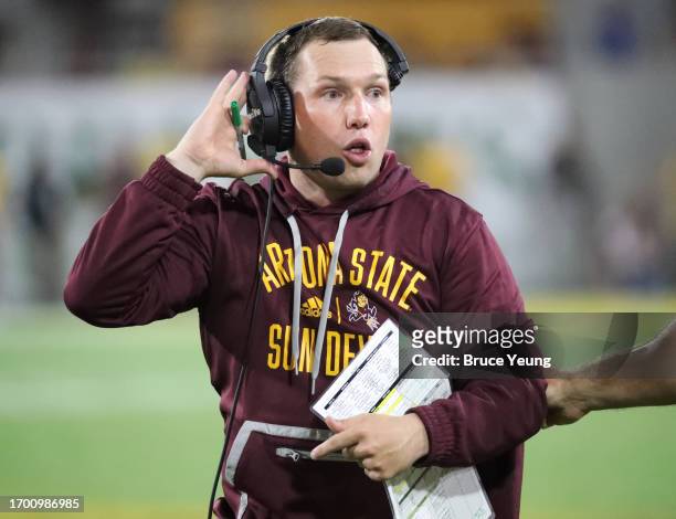 Head Coach Kenny Dillingham of the Arizona State Sun Devils discusses a play on the headset with his coaches in the second quarter against the...